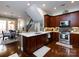 A gourmet kitchen featuring wooden cabinets, stainless appliances, and a bright, white countertop at 6301 Park South Dr, Charlotte, NC 28210