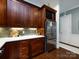 Gourmet kitchen features stainless steel appliances and elegant wooden cabinets for ample storage at 6301 Park South Dr, Charlotte, NC 28210