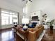 Bright and airy living room featuring a fireplace, hardwood floors, and high ceilings at 6301 Park South Dr, Charlotte, NC 28210