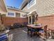 Paver patio with a round table, seating for six, and plush cushions surrounded by a brick privacy wall at 6301 Park South Dr, Charlotte, NC 28210