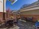 Private paver patio with a table, chairs, brick surround, and tasteful patio furniture perfect for entertaining at 6301 Park South Dr, Charlotte, NC 28210