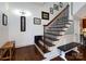 Inviting staircase with patterned risers, wood treads, and decorative wall art at 6301 Park South Dr, Charlotte, NC 28210