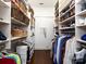 Organized walk-in closet with custom shelving, rods, and ample storage space at 6301 Park South Dr, Charlotte, NC 28210