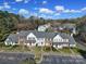 Aerial view of well-maintained townhomes showcasing parking and landscaping at 6310 Windsor Gate Ln # 15, Charlotte, NC 28215