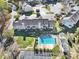 Aerial view of townhomes with community pool and parking areas on a sunny day at 6310 Windsor Gate Ln # 15, Charlotte, NC 28215
