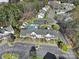 Aerial view featuring townhomes, community pool, landscaping, and parking area at 6310 Windsor Gate Ln # 15, Charlotte, NC 28215