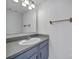 Simple bathroom featuring a single sink vanity, mirror, and essential fixtures at 6310 Windsor Gate Ln # 15, Charlotte, NC 28215