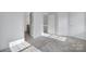 Spacious carpeted bedroom with a doorway leading to a bathroom, a closet, and a neutral color scheme at 6310 Windsor Gate Ln # 15, Charlotte, NC 28215