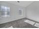 Bright bedroom with two windows offering natural light, neutral walls, and plush carpeting at 6310 Windsor Gate Ln # 15, Charlotte, NC 28215