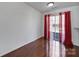 Bright bedroom featuring hardwood floors, sliding doors to the backyard, and neutral walls at 6310 Windsor Gate Ln # 15, Charlotte, NC 28215