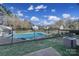 Community pool surrounded by a black fence and landscaping at 6310 Windsor Gate Ln # 15, Charlotte, NC 28215