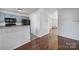 Open-concept dining area with hardwood floors, open view into the kitchen, and neutral walls at 6310 Windsor Gate Ln # 15, Charlotte, NC 28215