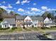 Aerial view of townhomes featuring manicured lawns and ample parking at 6310 Windsor Gate Ln # 15, Charlotte, NC 28215