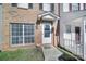 Close-up of townhome entrance with glass door and trimmed shrubbery at 6310 Windsor Gate Ln # 15, Charlotte, NC 28215