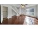 Sunlit living room with hardwood floors, staircase, and a view into the bathroom at 6310 Windsor Gate Ln # 15, Charlotte, NC 28215