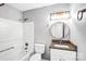 Updated bathroom featuring granite countertop, white cabinets, and shower-tub combo at 6628 Cool Water Ct, Charlotte, NC 28215