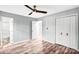 Neutral bedroom with wood-look flooring, ceiling fan, closet, and white trim at 6628 Cool Water Ct, Charlotte, NC 28215