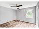 A well lit bedroom features wood-look flooring and a ceiling fan at 6628 Cool Water Ct, Charlotte, NC 28215