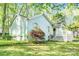 Charming home exterior with a manicured lawn and blooming azalea bushes at 6628 Cool Water Ct, Charlotte, NC 28215