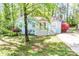 Charming blue brick home with a white picket fence and lush landscaping at 6628 Cool Water Ct, Charlotte, NC 28215