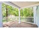 Inviting front porch with wood floors and open views of the surrounding trees at 6628 Cool Water Ct, Charlotte, NC 28215