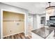 Open kitchen view with white cabinets, granite countertops, stainless steel appliances, and a laundry area at 6628 Cool Water Ct, Charlotte, NC 28215