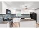 Modern kitchen featuring white cabinets, granite countertops, and stainless steel appliances at 6628 Cool Water Ct, Charlotte, NC 28215