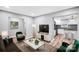 Comfortable living room with modern decor, wood floors and a view of kitchen at 6628 Cool Water Ct, Charlotte, NC 28215