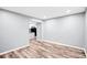 Bright, empty living room with modern wood floors and a view into the kitchen at 6628 Cool Water Ct, Charlotte, NC 28215
