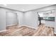 Bright living room with wood floors offering a view of the modern kitchen at 6628 Cool Water Ct, Charlotte, NC 28215
