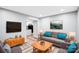 Cozy living room with stylish decor, wood flooring and a view into the kitchen at 6628 Cool Water Ct, Charlotte, NC 28215