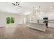 An open-concept living space featuring a kitchen with white cabinets and a large island at 7012 Jerimoth Dr, Charlotte, NC 28215