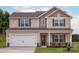 Charming two-story home with a two-car garage, covered entry, and manicured lawn at 7113 Jerimoth Dr, Charlotte, NC 28215