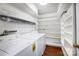 Bright laundry room with washer, dryer, and ample shelving at 7213 Quail Meadow Ln, Charlotte, NC 28210