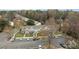 Aerial view of townhomes surrounded by trees, with visible parking and landscaped areas at 7707 Petrea Ln, Charlotte, NC 28227