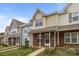 Attractive row of townhomes with well-maintained front yards and diverse facades at 7707 Petrea Ln, Charlotte, NC 28227