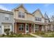 Charming townhome with brick and siding exterior, featuring a covered porch at 7707 Petrea Ln, Charlotte, NC 28227