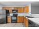 Functional kitchen with dark appliances, wood cabinets, and updated countertops at 7707 Petrea Ln, Charlotte, NC 28227