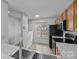 Bright kitchen features stainless steel sink, tile flooring, and window view at 7707 Petrea Ln, Charlotte, NC 28227