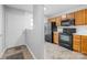 Well-equipped kitchen with oak cabinets and black appliances for modern living at 7707 Petrea Ln, Charlotte, NC 28227