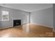 Cozy living room featuring a fireplace, sliding glass door and laminate flooring at 7707 Petrea Ln, Charlotte, NC 28227