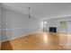 Cozy living room featuring a fireplace, bright lighting, and a sliding glass door at 7707 Petrea Ln, Charlotte, NC 28227