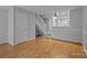 Inviting living room with hardwood floors, staircase, and neutral paint at 7707 Petrea Ln, Charlotte, NC 28227