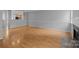 Open-concept living area featuring hardwood floors and a fireplace, perfect for entertaining at 7707 Petrea Ln, Charlotte, NC 28227