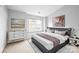 Calm main bedroom featuring a large window and stylish decor at 7707 Petrea Ln, Charlotte, NC 28227