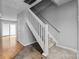 Staircase with carpeted steps and white railings at 7707 Petrea Ln, Charlotte, NC 28227