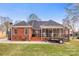 Brick home showcasing the back of the house and the patio with a screened-in porch at 801 Toncin Ave, Bessemer City, NC 28016