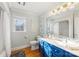 Bright bathroom featuring a blue vanity, white countertops, and decorative mirrors at 801 Toncin Ave, Bessemer City, NC 28016