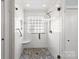 The bright shower features white subway tile, stone flooring, and a glass door at 801 Toncin Ave, Bessemer City, NC 28016