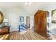 Bedroom featuring wood laminate floors, vaulted ceiling, a desk, and a large armoire at 801 Toncin Ave, Bessemer City, NC 28016